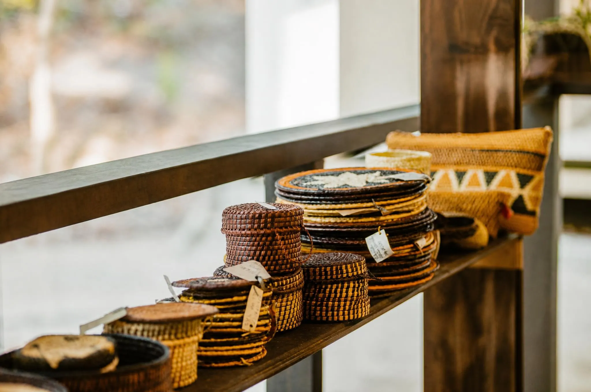 A shelf with baskets, pots and bags of woven palm from the region's craftwork